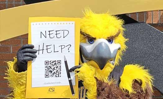 Gilbert the golden eagle mascot holding a need help poster 