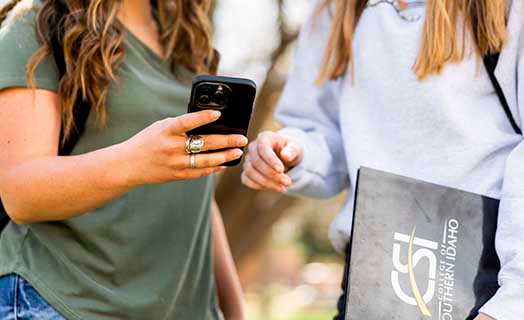 students holding a phone